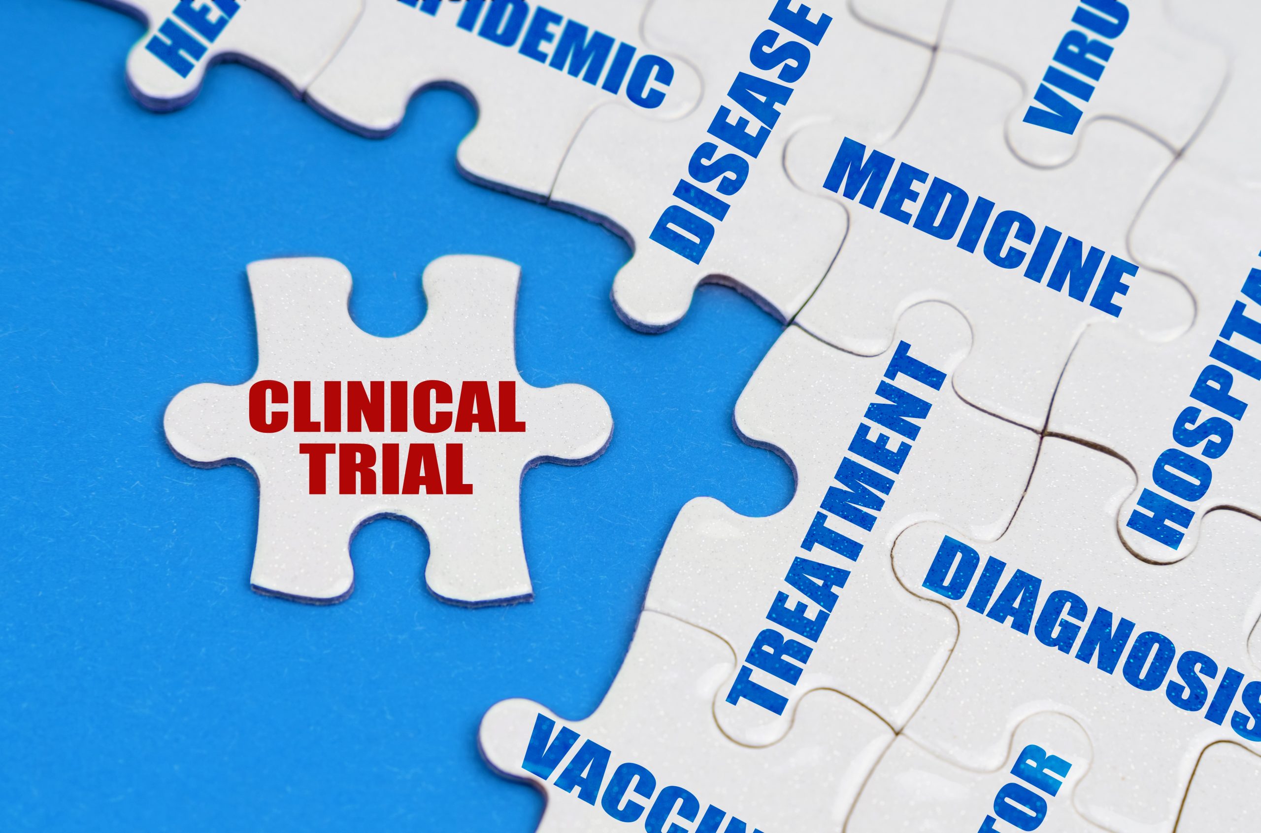 puzzle pieces, one with red clinical trial wording